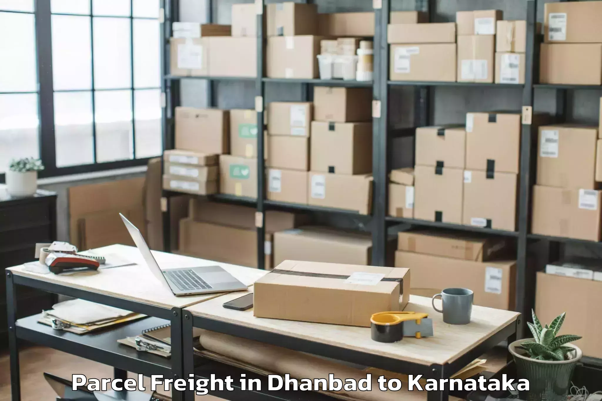 Book Dhanbad to Karnataka State Rural Developm Parcel Freight Online